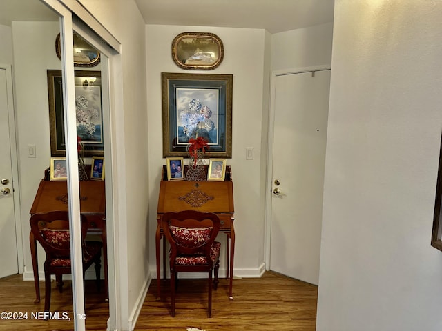 corridor with hardwood / wood-style floors