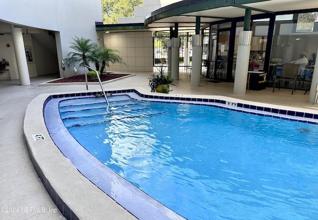 view of swimming pool featuring a patio area