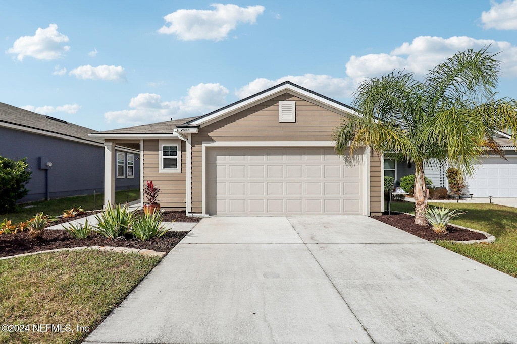 ranch-style home featuring a garage