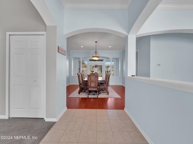 hallway featuring light hardwood / wood-style floors and crown molding