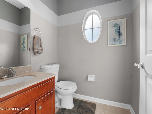 bathroom featuring tile patterned flooring, vanity, and toilet