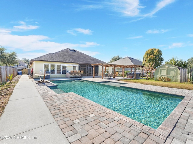 view of swimming pool featuring a patio area and a storage unit