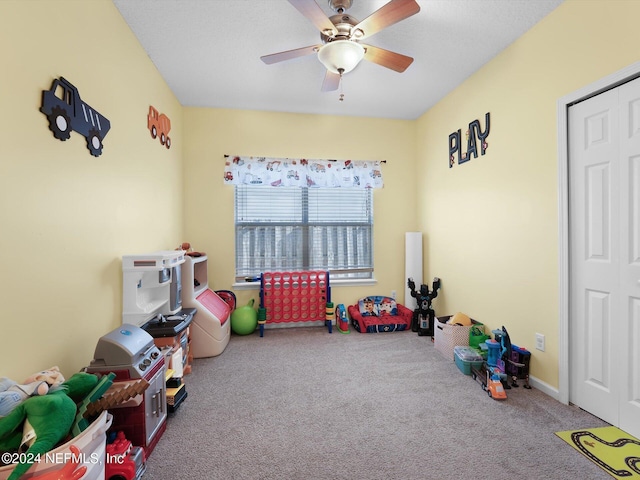 recreation room featuring carpet flooring and ceiling fan