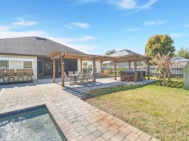 exterior space with a pergola, exterior bar, a yard, a patio, and a hot tub