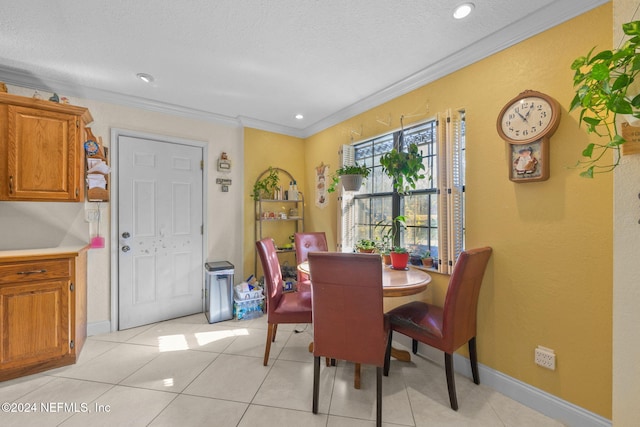 dining space with crown molding, light tile patterned floors, and a textured ceiling