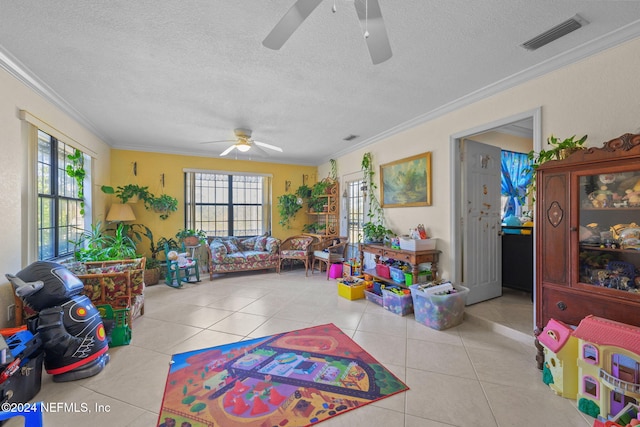 rec room with light tile patterned floors, a wealth of natural light, and crown molding