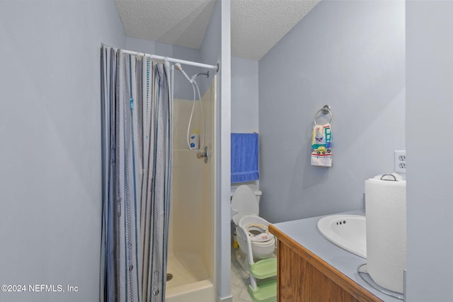 bathroom featuring vanity, a shower with curtain, and a textured ceiling