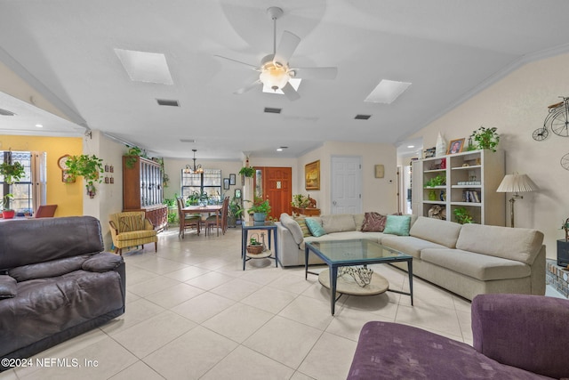 living room featuring light tile patterned floors, crown molding, and lofted ceiling with skylight