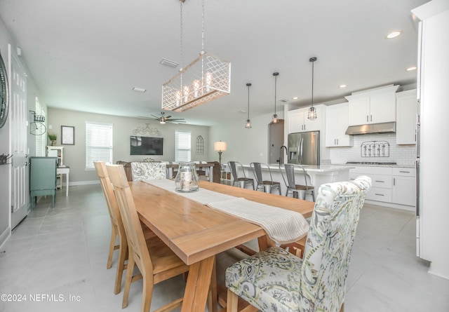 tiled dining area with ceiling fan