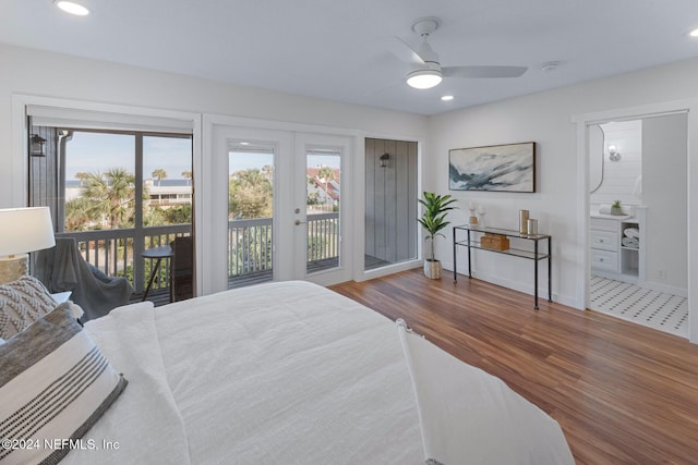 bedroom featuring access to exterior, french doors, ensuite bathroom, ceiling fan, and wood-type flooring