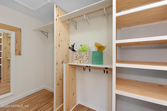 spacious closet featuring hardwood / wood-style floors