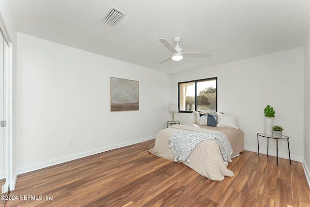 bedroom featuring hardwood / wood-style flooring and ceiling fan