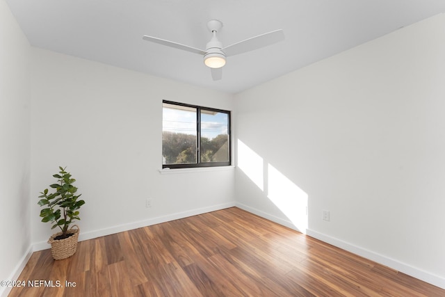 spare room featuring hardwood / wood-style floors and ceiling fan