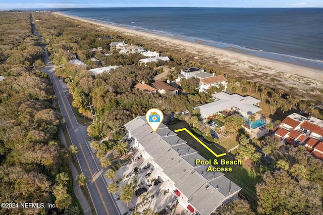 bird's eye view featuring a water view and a beach view