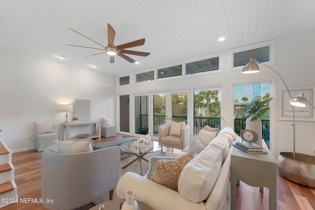 living room featuring french doors, light hardwood / wood-style floors, ceiling fan, and wood ceiling