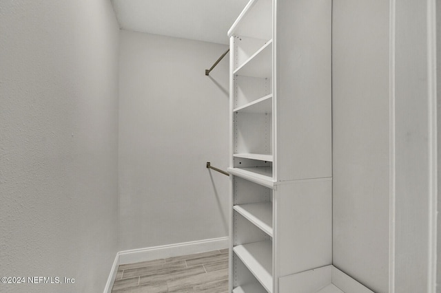 spacious closet featuring light hardwood / wood-style flooring