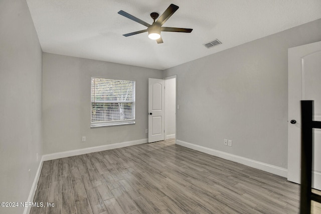 spare room featuring ceiling fan and light hardwood / wood-style flooring