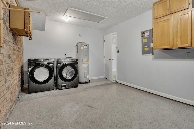 laundry area featuring cabinets, electric water heater, electric panel, independent washer and dryer, and a textured ceiling