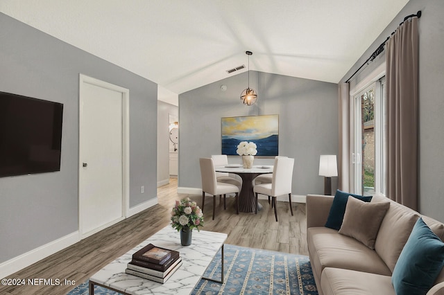 living room with lofted ceiling and light wood-type flooring