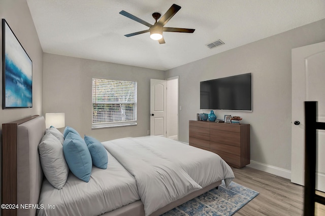 bedroom featuring light hardwood / wood-style floors and ceiling fan