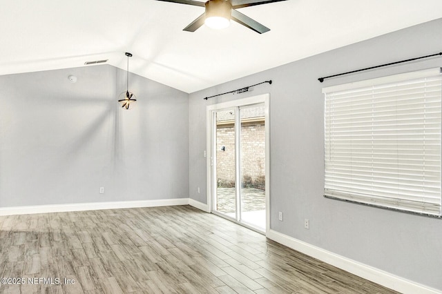 unfurnished room featuring hardwood / wood-style flooring, vaulted ceiling, and ceiling fan