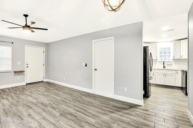 unfurnished living room with ceiling fan and light hardwood / wood-style floors