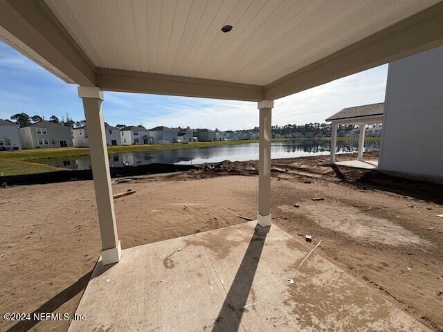 view of yard with a water view and a patio area