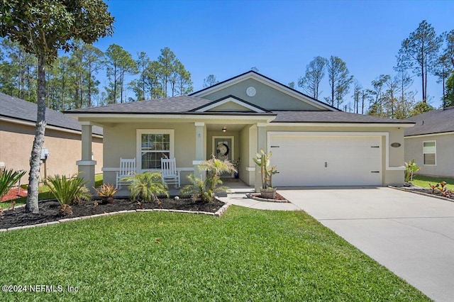 view of front of house with a porch, a garage, and a front yard