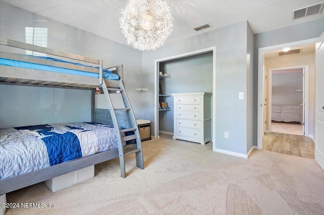 carpeted bedroom featuring a chandelier