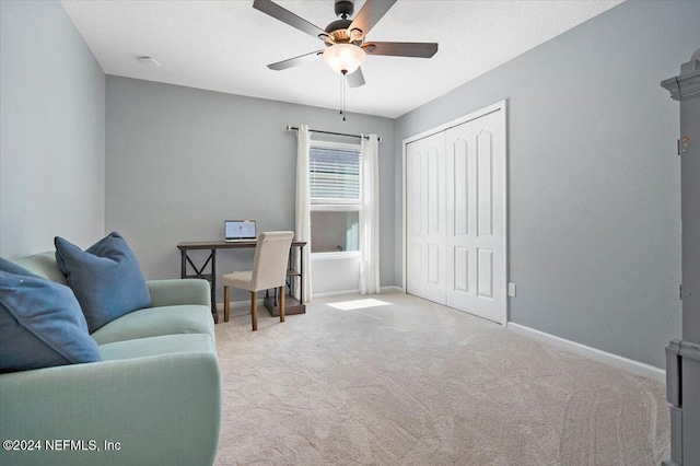 office space with ceiling fan and light colored carpet