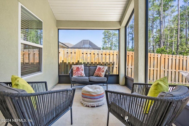 sunroom / solarium featuring lofted ceiling and wood ceiling