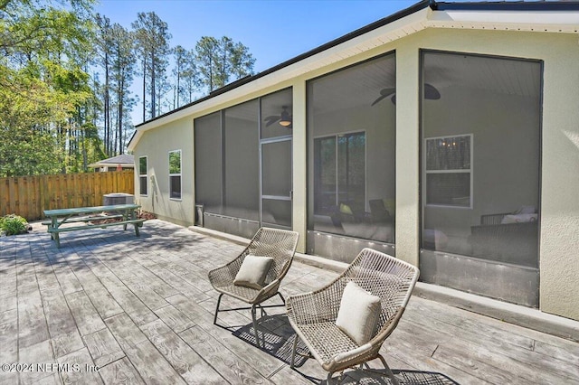 view of patio with a deck and a sunroom