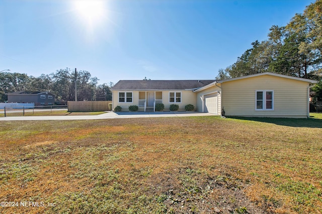 ranch-style house featuring a front yard and a garage