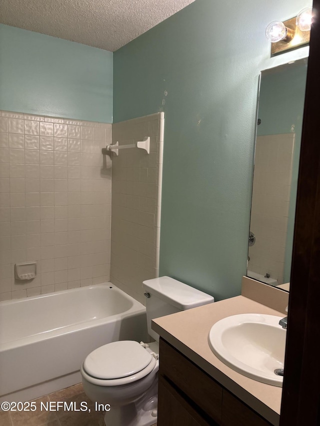 full bathroom featuring tile patterned floors,  shower combination, a textured ceiling, toilet, and vanity