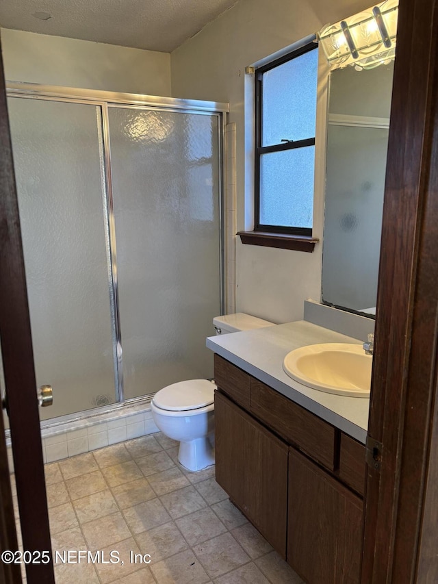 bathroom featuring vanity, toilet, and walk in shower