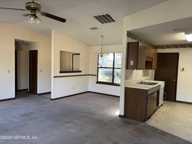 kitchen featuring light carpet, sink, and lofted ceiling