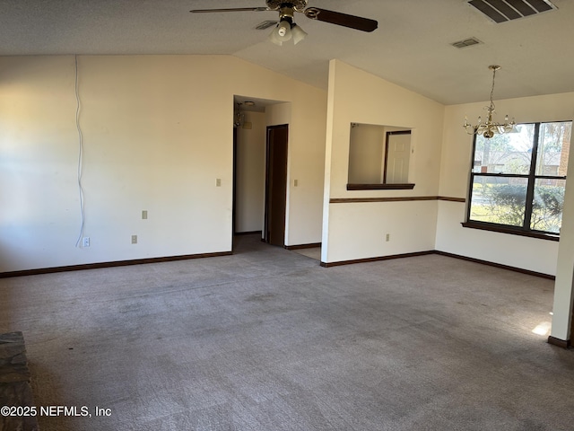 carpeted spare room with ceiling fan with notable chandelier and vaulted ceiling