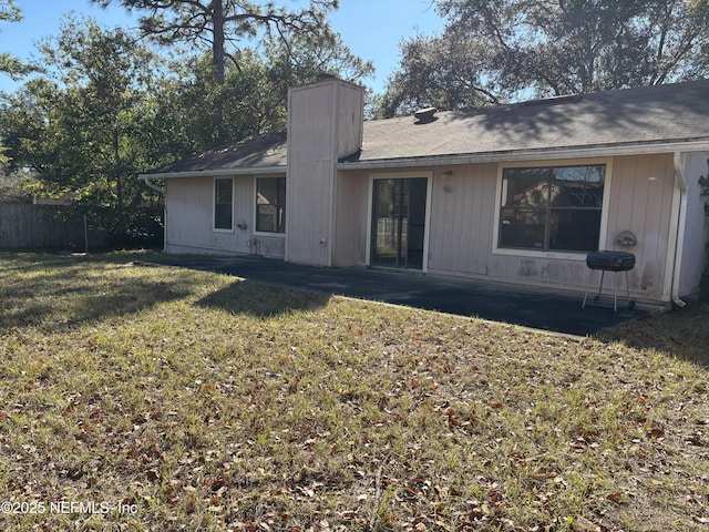 rear view of house with a lawn