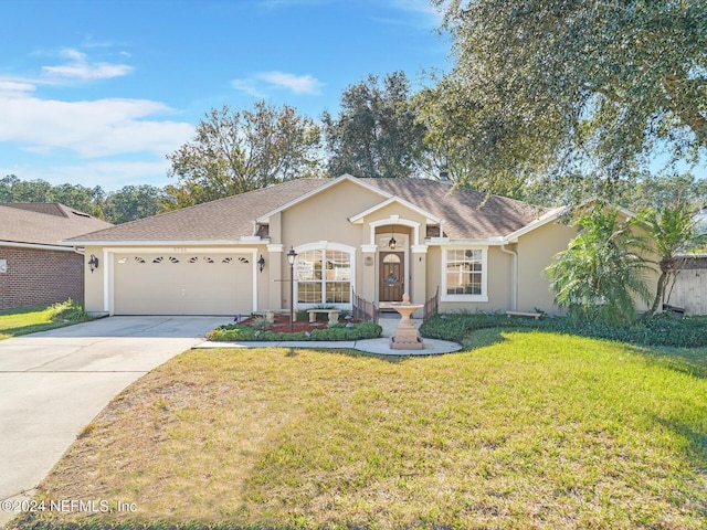 ranch-style home featuring a garage and a front lawn