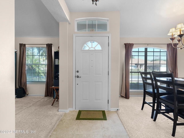 carpeted foyer with plenty of natural light