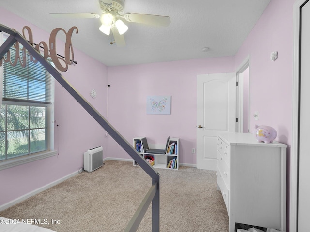 exercise area with carpet and ceiling fan