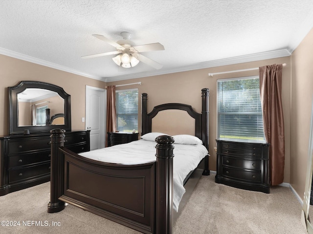 bedroom with a textured ceiling, ceiling fan, ornamental molding, and light carpet