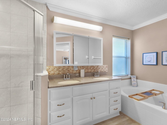 bathroom featuring shower with separate bathtub, hardwood / wood-style floors, a textured ceiling, and ornamental molding