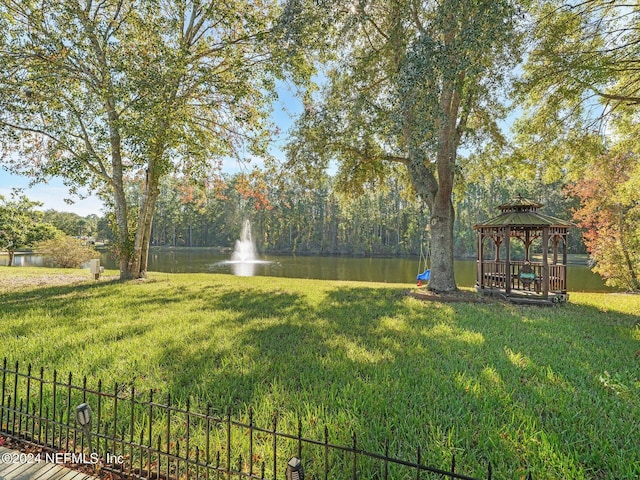 view of yard with a gazebo and a water view