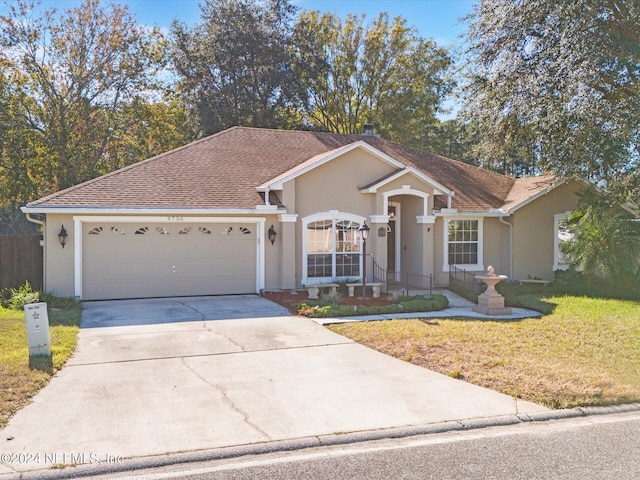 ranch-style home featuring a garage and a front lawn