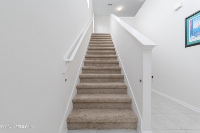 stairway with tile patterned floors