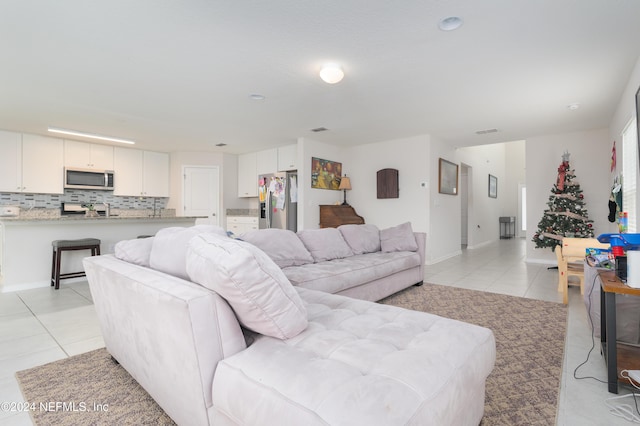 714 Meadow Ridge Dr, Saint Augustine, FL 32092 - living room with light tile patterned flooring and baseboards
