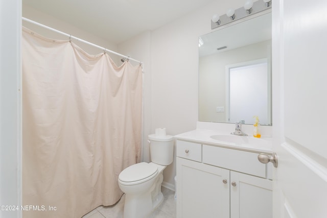 bathroom with tile patterned flooring, vanity, a shower with shower curtain, and toilet