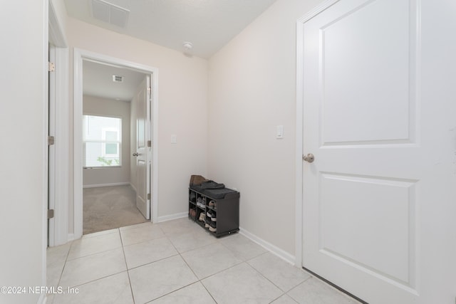 hallway with light tile patterned floors