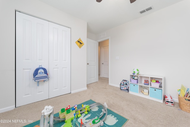 playroom with light carpet and ceiling fan